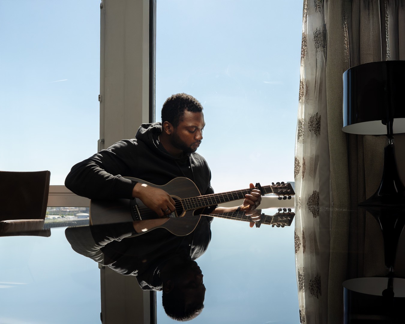 Image of Emmanuel playing a guitar